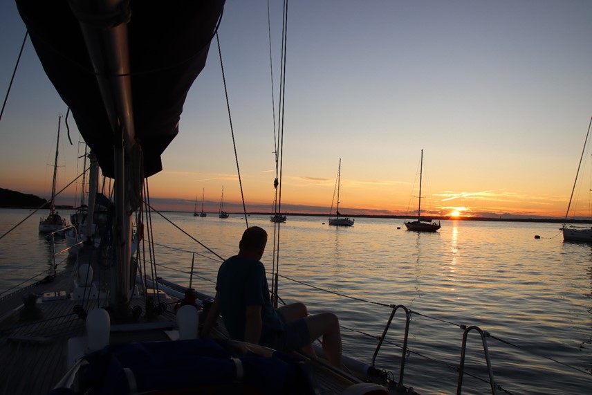 Sunset from the deck of WeatherWitch on a mooring buoy off Yarmouth, start of summer sailing adventures.