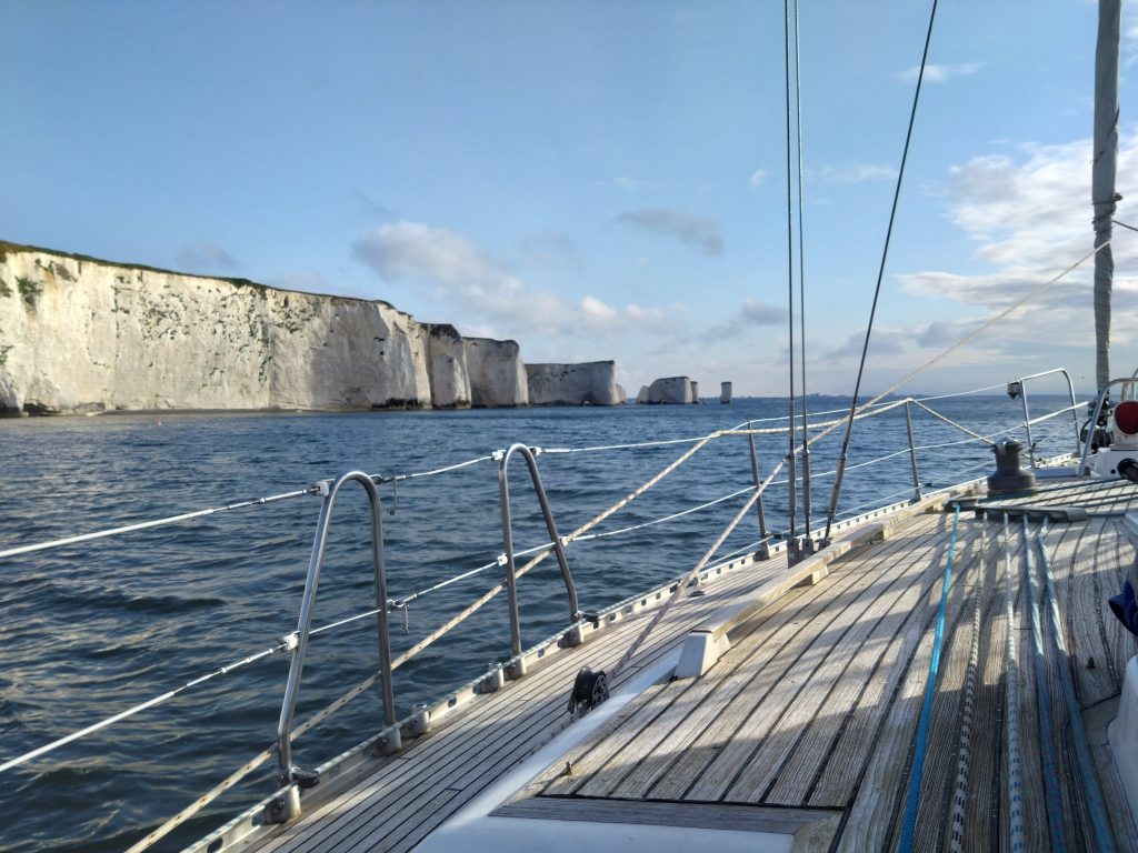 Side deck of WeatherWitch with Old Harry Rocks in the background.