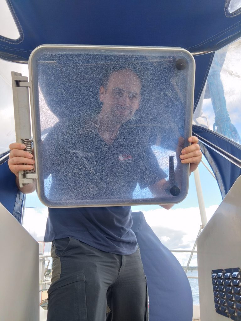 Mike looking through a very crazed hatch lid that has been removed from the hatch.
