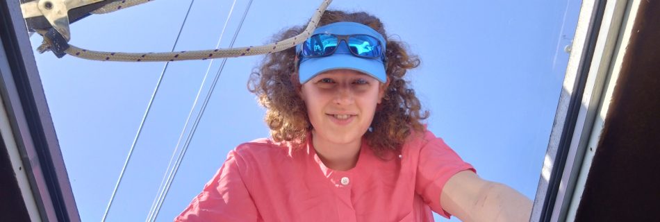 Looking up through clear new hatch to see person in pink shirt